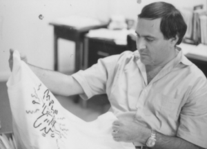 Queens Museum curator Marc H. Miller examines a Keith Haring t-shirt, c. 1985. Photo by Phyllis Bilick.
